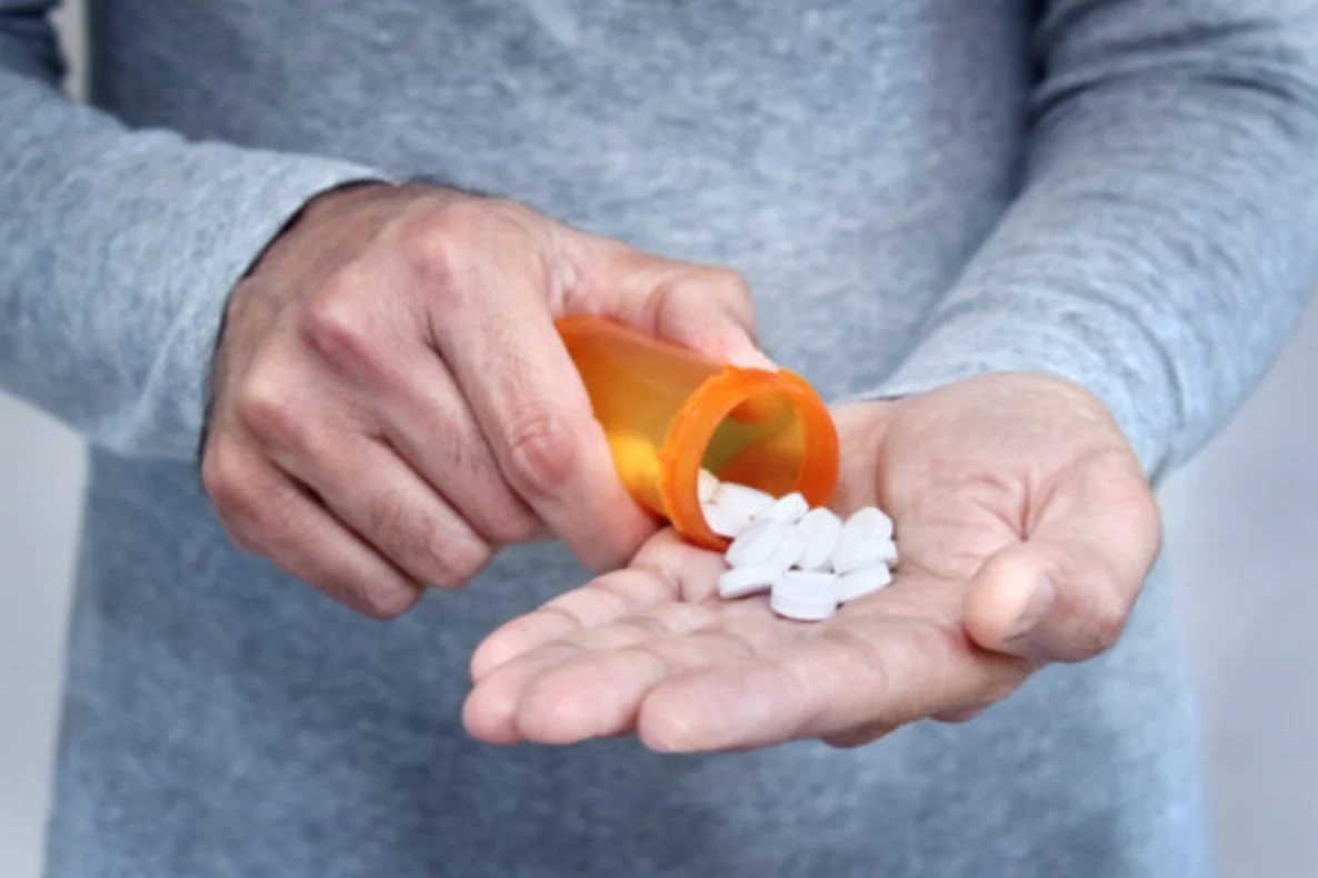 man holding a pill bottle